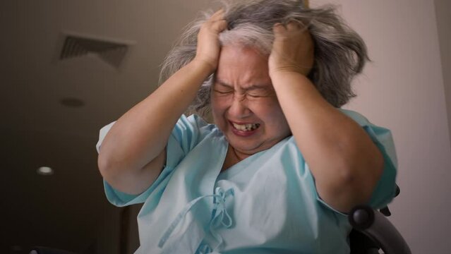 Asian senior adult woman suffering from a mental disorder breakdown sickness, mental disorder concept, negative emotion, Alzheimer, depression and difficult life situation concept