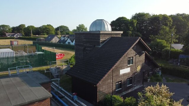 Aerial view orbiting Leighton observatory silver dome scientific astronomy building, Pex hill UK