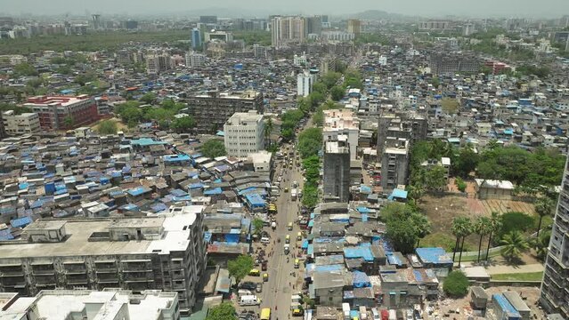 Establishing shot over bustling 90 feet road in Dharavi slum in Mumbai. India