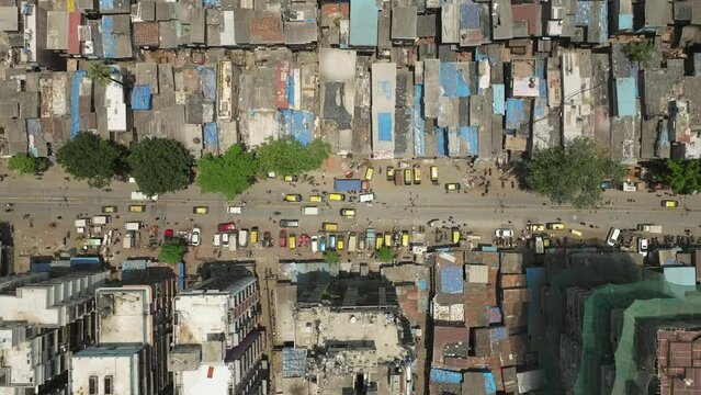 Drone Directly above of Dharavi slum with traffic in 90 feet road, Static shot