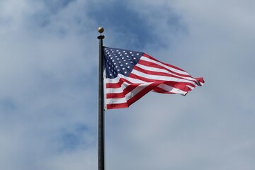 American flag on blue sky background