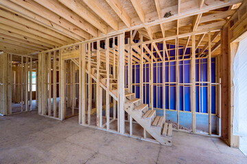 Under construction new house requires installation wooden beams as inside frame support