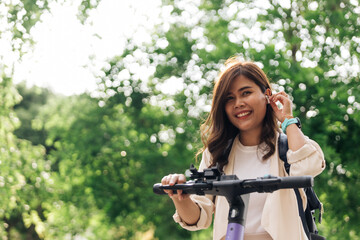 Fototapeta na wymiar Happy young asian woman riding a bicycle in the park. Healthy lifestyle concept.
