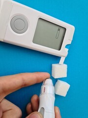 Boy using glucometer checking blood sugar level