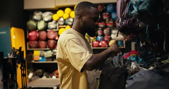 Empowering Exploration: An Afroamerican's Journey through a Specialized Hiking Gear Store, Selecting and Acquiring the Perfect Backpack for Adventurous Pursuits