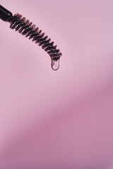 Cosmetic oil for the growth of eyebrows and eyelashes with a brush.