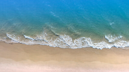 Aerial view with beach in wave of turquoise sea water shot, Top view of beautiful white sand background