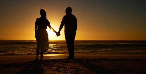 Beach, sunset and a silhouette couple holding hands on vacation or holiday outdoor. Behind man and woman in nature with creative art, mockup space and ocean for love, care and travel or freedom