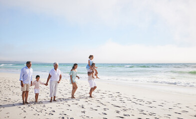 Big family, grandparents walking or children on beach with young siblings holding hands on holiday together. Dad, mom or kids love bonding, smiling or relaxing with senior grandmother or grandfather