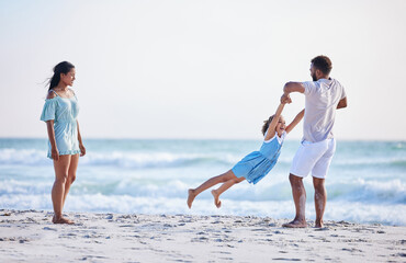 Mother, beach or father playing with child in air on family holiday, vacation or weekend break together. Parents, mom or dad swinging or bonding with child, daughter or kid at seaside with happiness