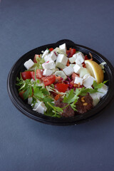  greek salad in a bowl on table.