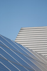 Fototapeta na wymiar Solar panels next to house roof
