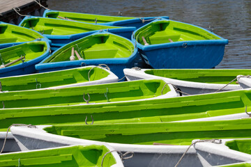 empty green rowing boats on a lake