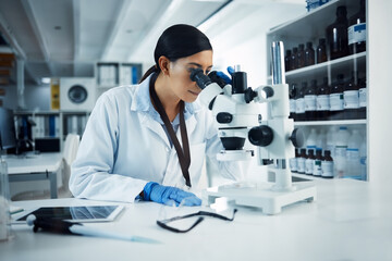 Woman, scientist and microscope analysis to check DNA sample with science experiment in laboratory....
