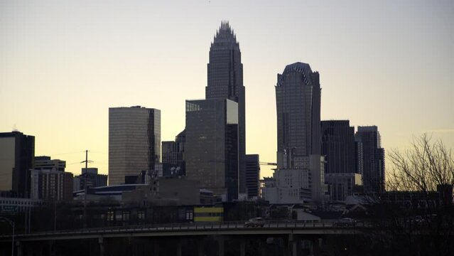 Lockdown Shot Of Vehicles On Bridge By Buildings Against Sky In City At Sunset - Charlotte, North Carolina