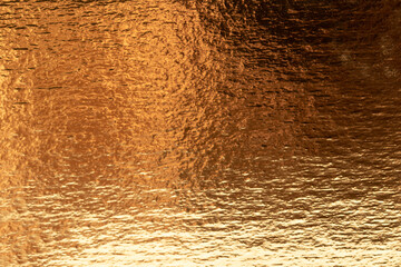 Abstract Defocused Gold foil texture background.