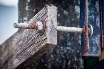 Rusty on nut, bolt and washer for attached to the old wooden plate long time.