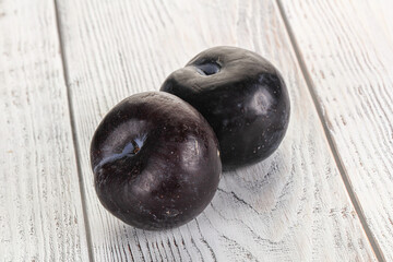 Two ripe sweet black plums