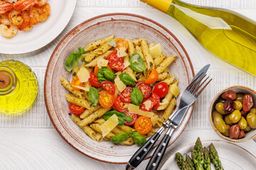 Italian pasta adorned with fresh tomatoes and aromatic basil