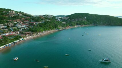 High panoramic view over João Fernandes beach, lined by inns and hotels