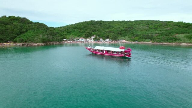 Tourist boat touring the shores of Azeda and Azedinha beach near Buzios, Flyover