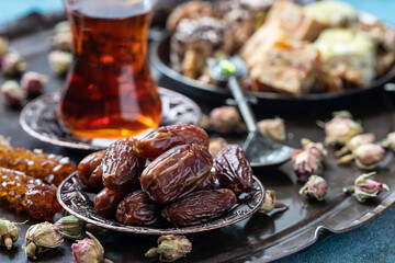 Turkish tea in traditional glass with sweet dates