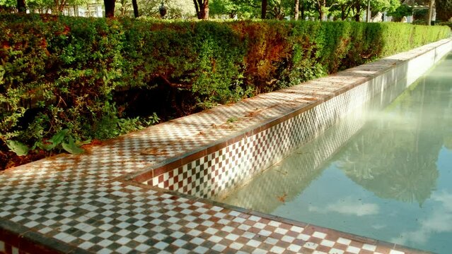 The Parque Maria Luisa, Seville, Andalusia, Spain, expansive lush park with gardens, fountains, monuments, and the impressive Plaza de Espana