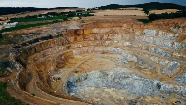 Open Pit Stone Quarry With Stepped Walls - aerial pullback