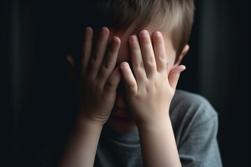 Boy crying covered his face with his hands, Stressed child, Domestic Family violence and aggression concept