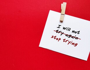 Note on copy space red background with handwritten text I WILL NOT TRY AGAIN change to  I WILL NOT...