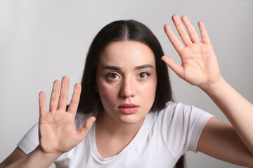 Young woman stuck to transparent screen. Internet addiction