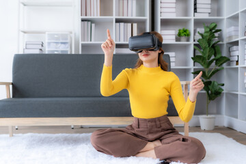 Smiling woman having fun using VR glasses playing game at home happily and enjoy virtual reality.