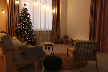 Tv area with cabinet, comfortable sofa, armchair and coffee table near Christmas tree in room