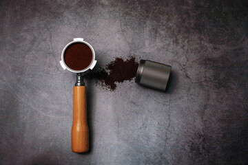 portafilter with ground coffee for espresso coffee maker on loft background