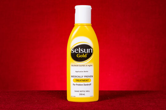 ZhongShan China-March 28,2023:bottle of Selsun Gold on red background horizontal composition.