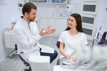 Fototapeta premium Beautiful young woman having dental treatment at dentist's office.