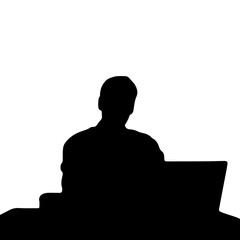 silhouette of a man sitting behind his desk working on his laptop with a cup of coffee