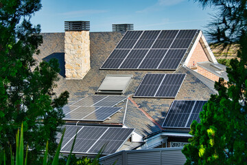 Fototapeta premium Roofs of singlefamily homes with solar energy panels