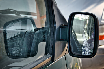 Broken rearview mirror of a car close up.