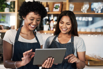 Happy woman, tablet and waitress in teamwork at cafe for inventory, checking stock or orders at...