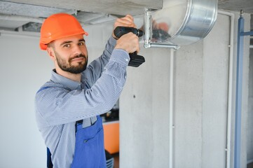 ventilation system installation and repair service. hvac technician at work. banner copy space.