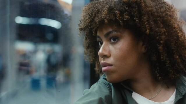 Young afro woman traveling by underground and looking through the window. Shot with RED helium camera in 8K. 