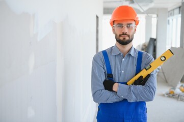 Construction Worker in blue uniform with spirit level