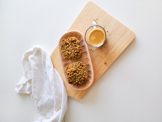 Coffee and muffins with crumble topping on wooden board