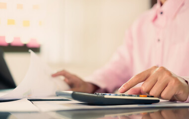 Fototapeta premium The businessman hand sits at their desks and calculates financial graphs showing the results of their investments planning the process of successful business growth