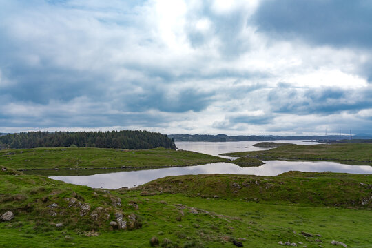 Panorama of the beautiful landscape of the island of Karmoy in Rogaland, Norway, with dark cloudy sky