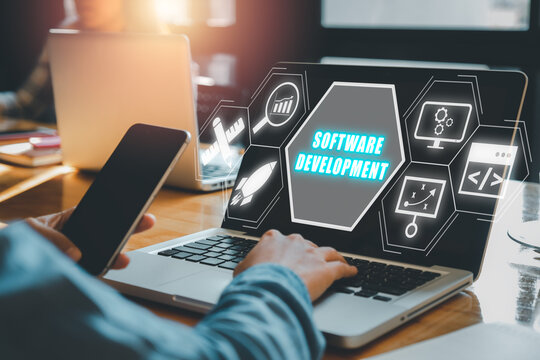 Software development concept, Person working on laptop computer with software development icon on virtual screen.