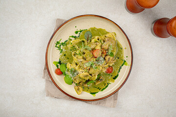 Portion of gourmet pasta fettuccine with pesto sauce