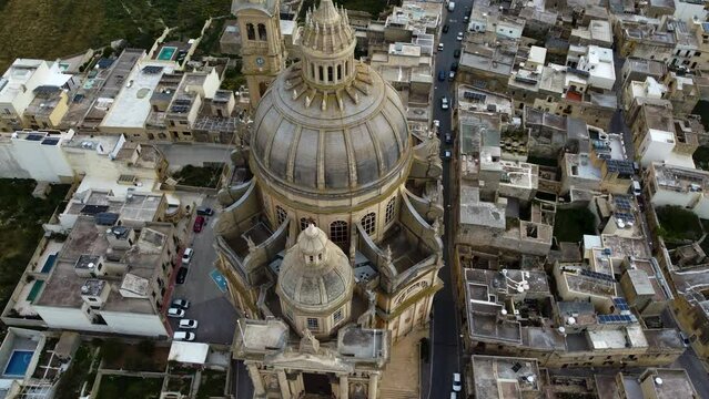 basilica church of Roman Catholic parish church, Symbolic to holy mother Mary, religious built sacret architecture, dome with cross symbol on top, tilt up aerial drone movement, shot in malta. 