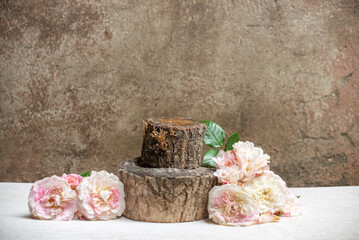 Mockup for product design and presentation from wooden saw cuts, a fragrant white-pink rose on the...